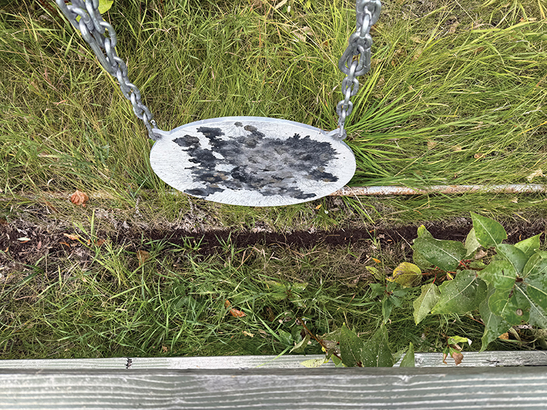 Bullet trough under gong.